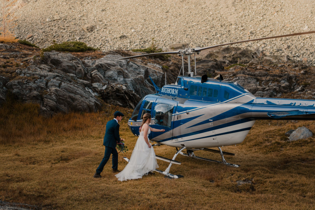 bride and groom getting into helicopter