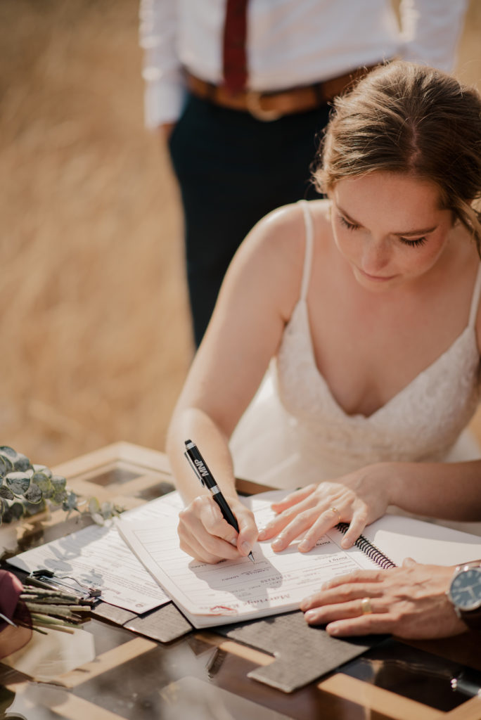 signing the official documents after the elopement ceremony