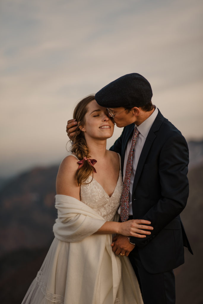 sunset helicopter elopement bride and groom kissing