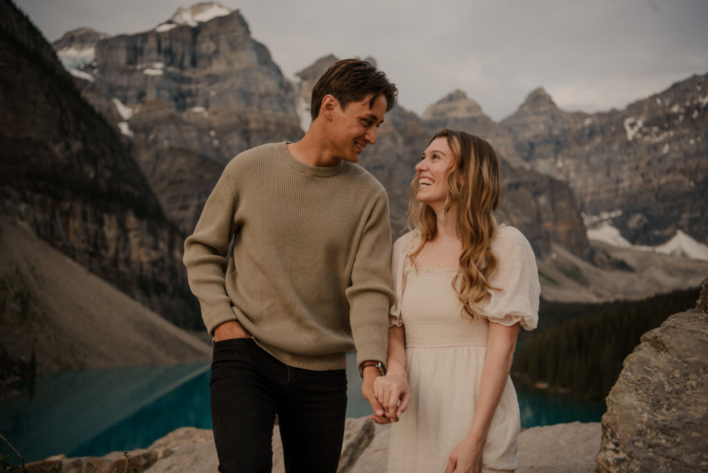 couple smiling during engagement session at moraine lake