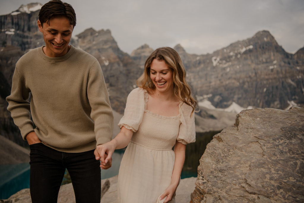 couple laughing during engagement session at moraine lake