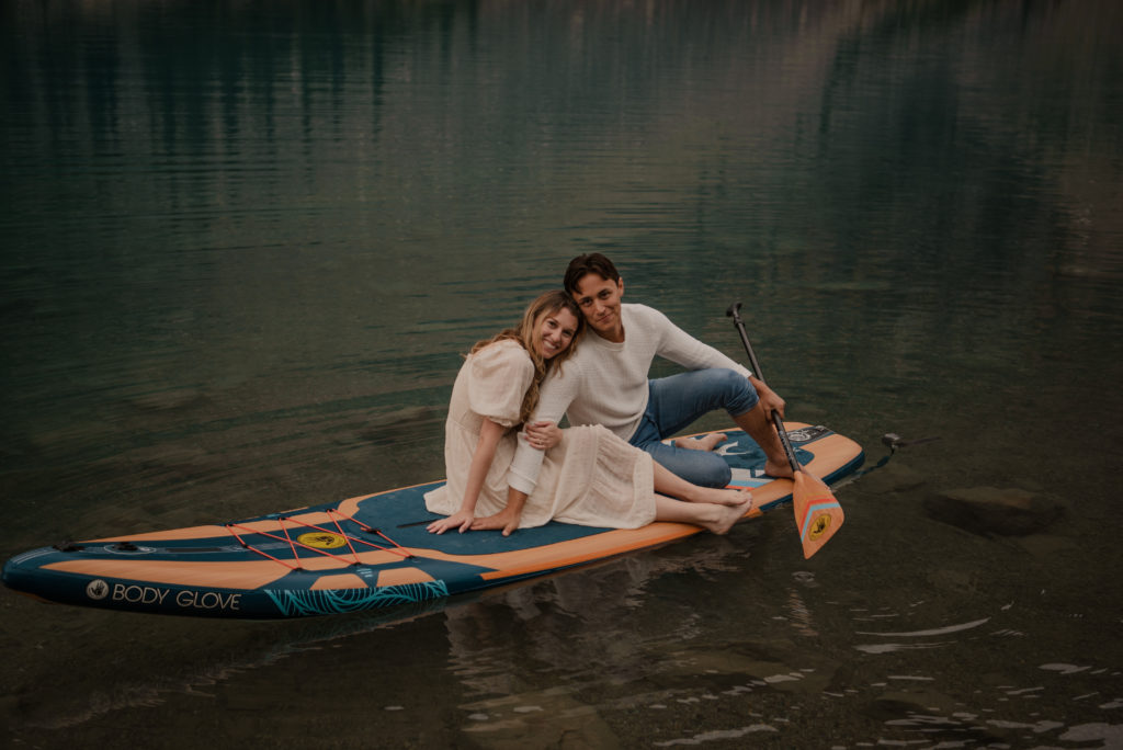 couple on paddleboard during engagement session at moraine lake