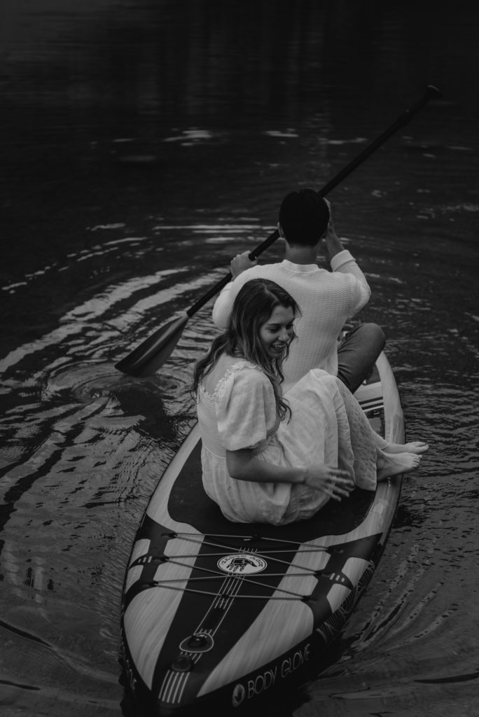 couple on paddleboard during engagement session at moraine lake