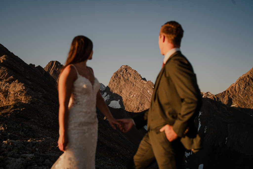jagged mountain peak between wedding couple on a mountain 