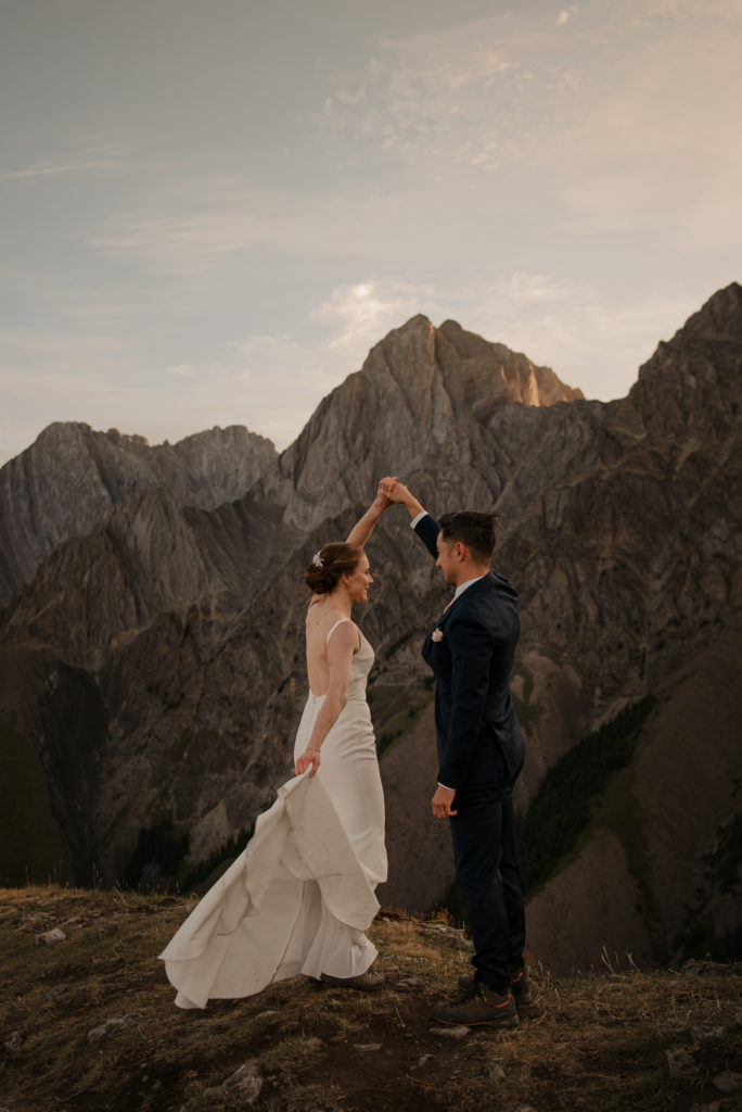 Wedding couple dancing on top of a mountain in Kananaskis.  