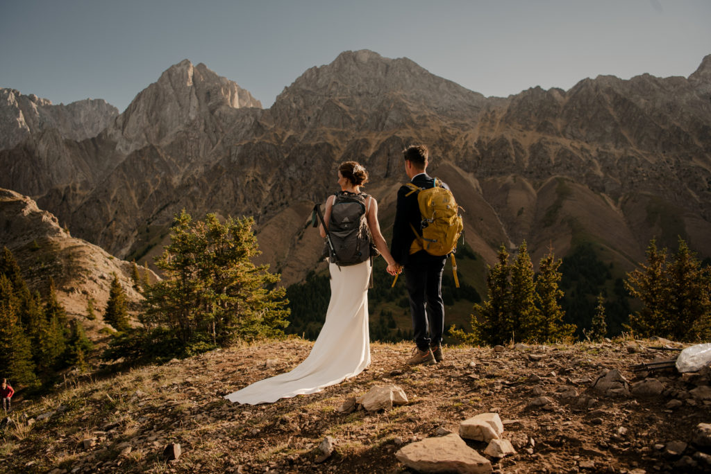 Wedding couple with backpacks after hiking elopement in Kananaskis