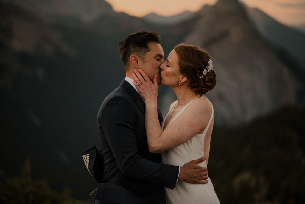 First kiss wedding couple in the mountains in Alberta
