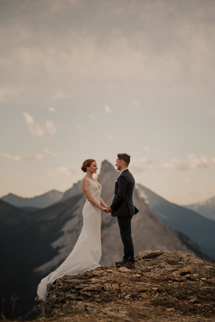 Sunrise hiking elopement in Kananaskis Alberta with soft light and epic mountain backdrops. 