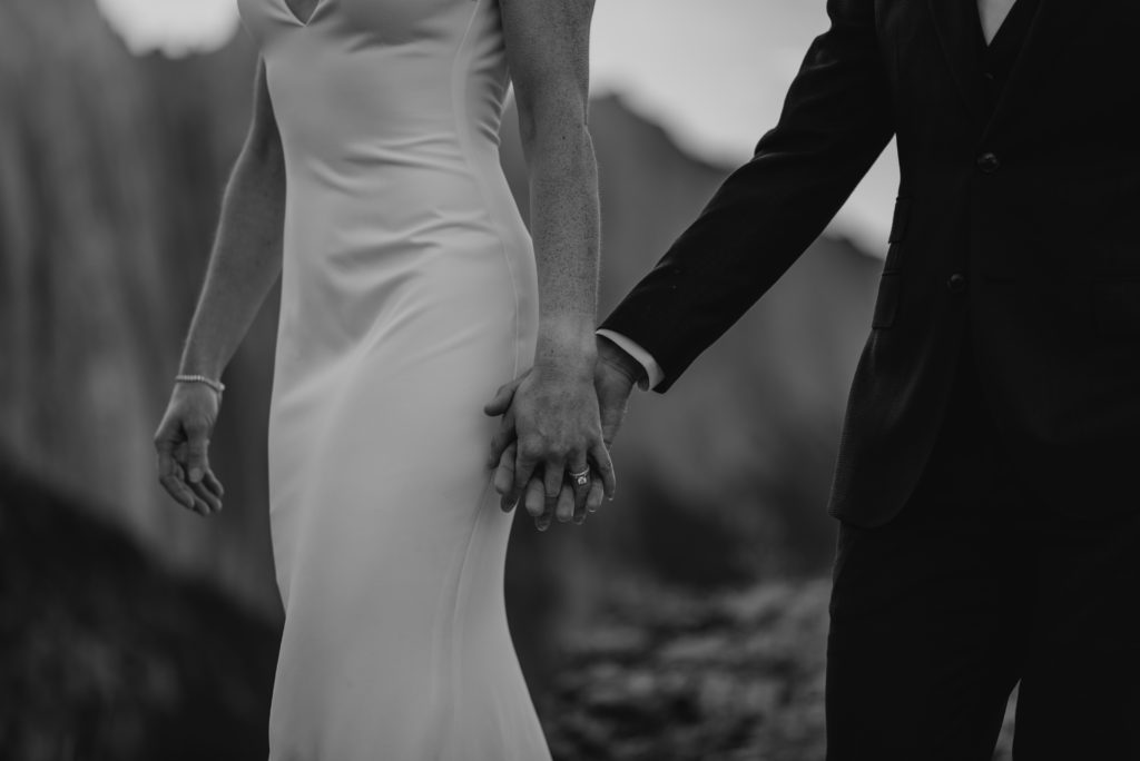 Closeup of hands with rings after couple got married on a mountain in Alberta. 