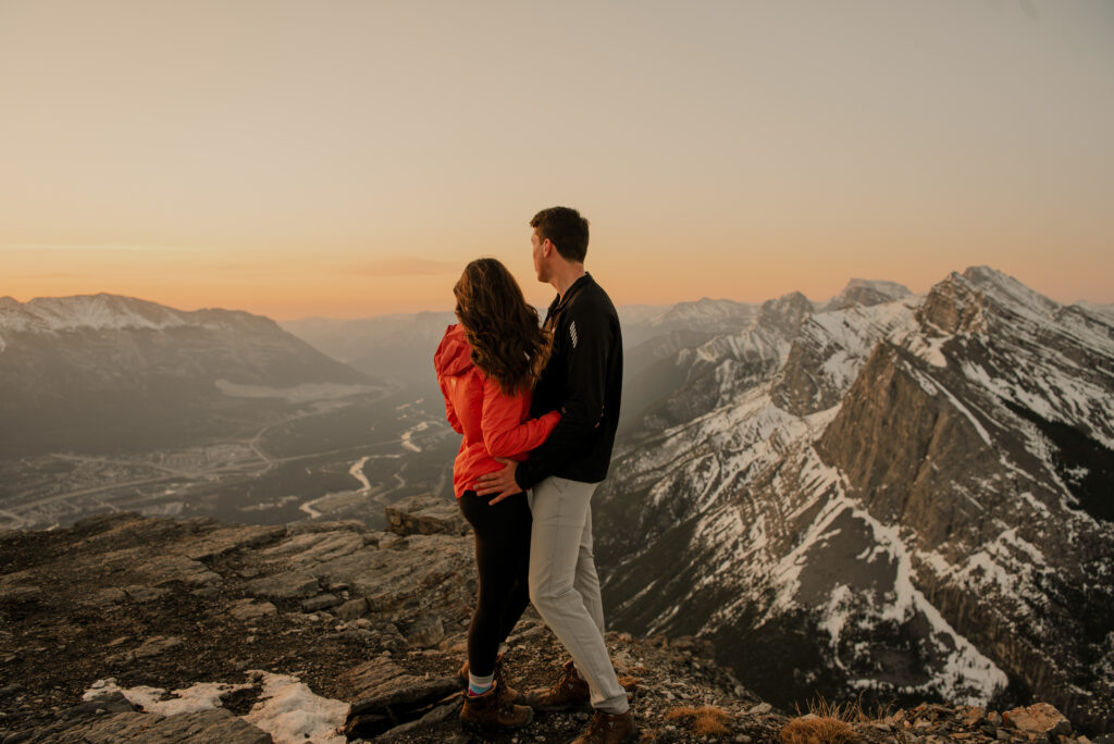 couple on top of a mountain at sunrise