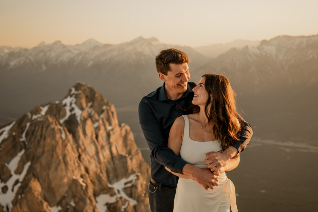 engagement photos at sunrise on a mountain in Canmore