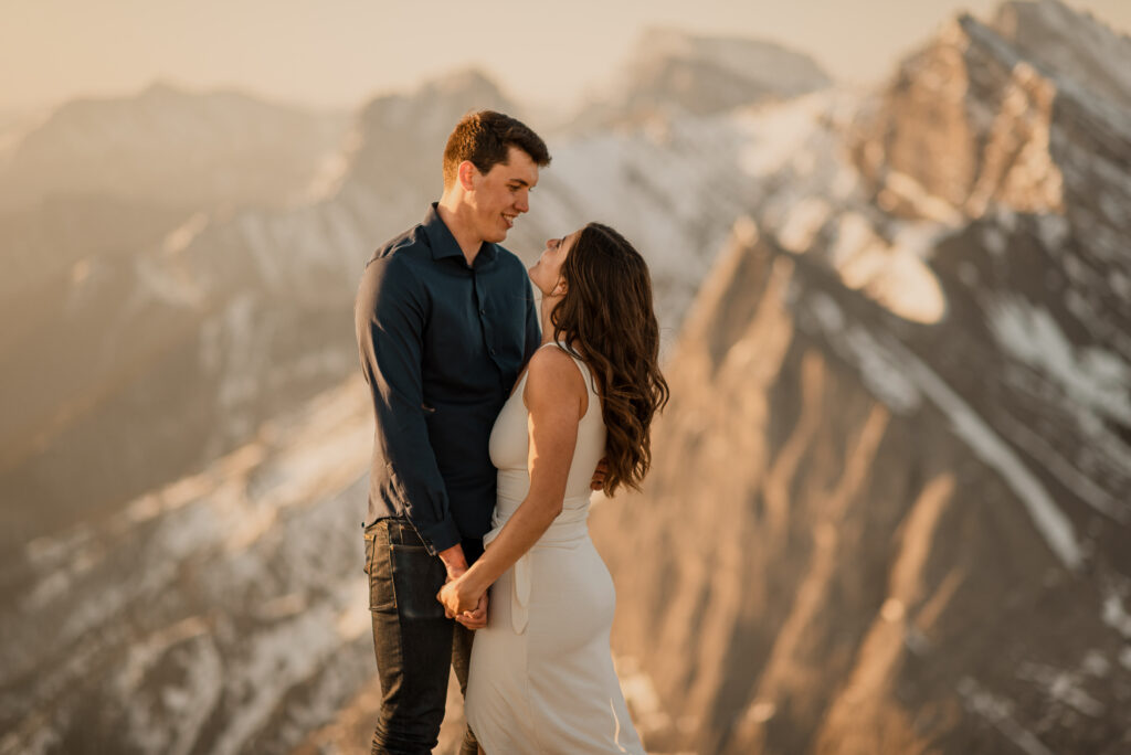 engagement photos at sunrise on a mountain in Canmore