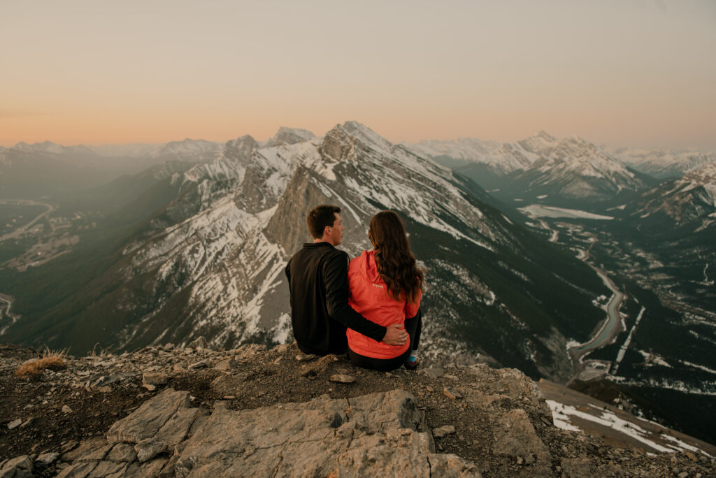 couple on top of a mountain at sunrise