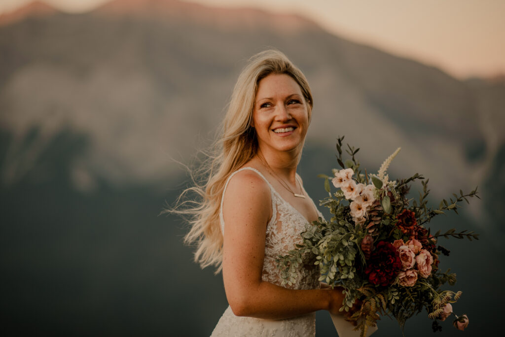 bride holding flowers before hiking elopement 