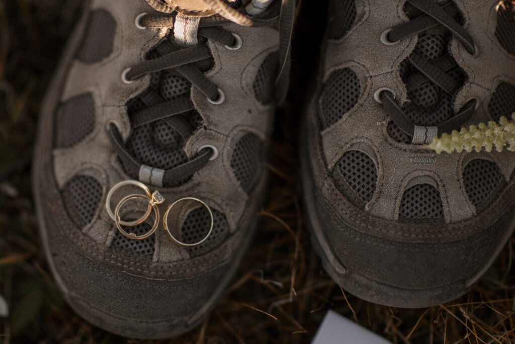 details of rings and hiking boots during adventure elopement