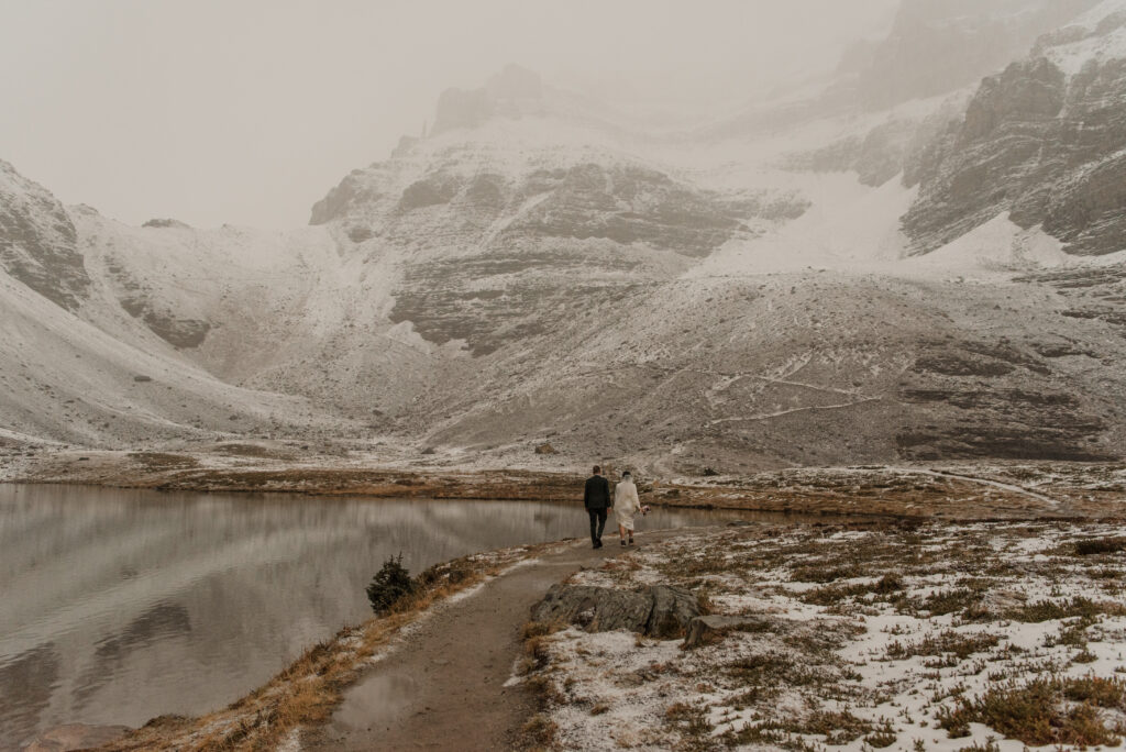 wedding couple hiking in snowy conditions banff alberta