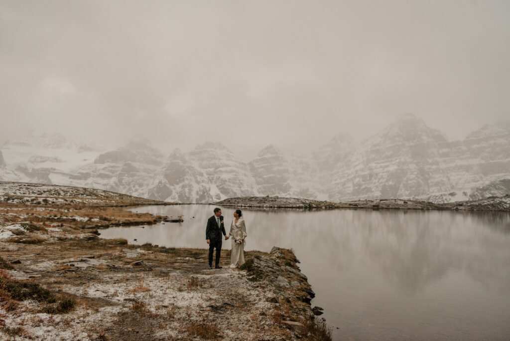 wedding couple hiking in snowy conditions banff alberta