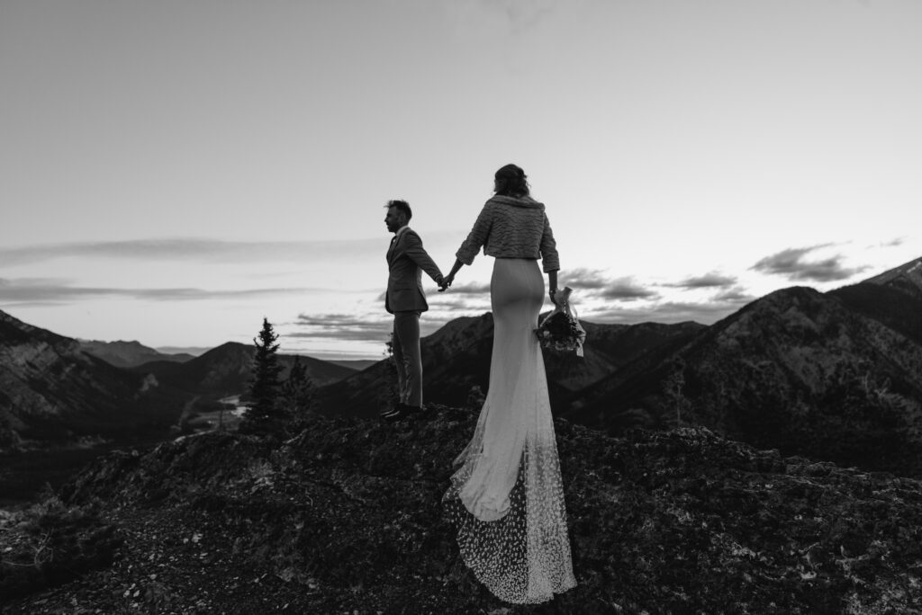 bride and groom on a mountain for hiking elopement