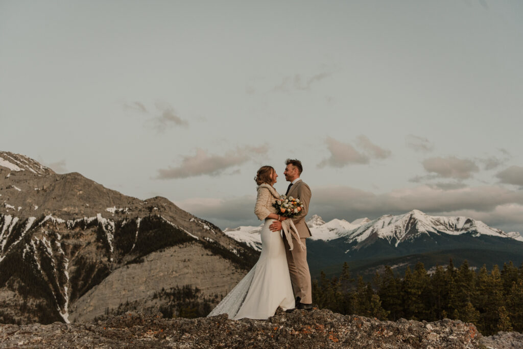 bride and groom on a mountain for hiking elopement