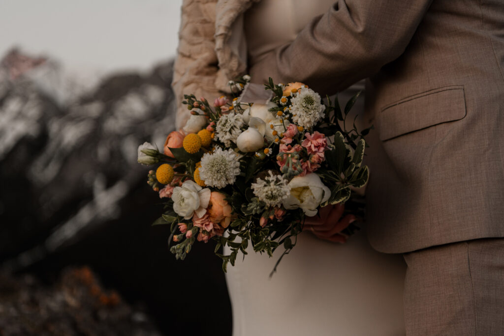 bride and groom on a mountain for hiking elopement