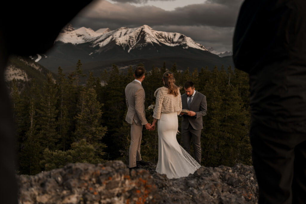 bride and groom on a mountain for hiking elopement